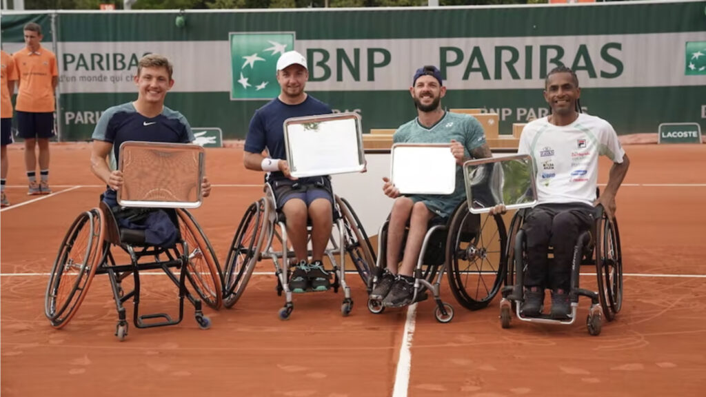 The quads doubles finalists at Roland Garros 2022 hold up their winners and runners-up trophies